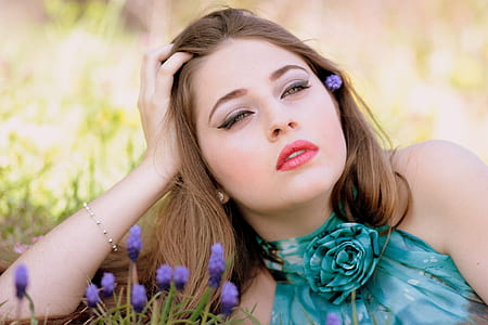 selective focus photo of woman resting her head on right hand thumbnail