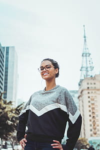 Woman Wearing Black and Gray Crew-neck Sweater Near Building at Daytime thumbnail