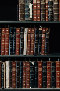 photo of piled brown, black, and beige hardbound book thumbnail