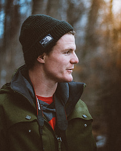man wearing black The North Face knit hat selective focus photography thumbnail