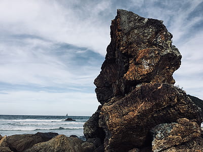 rock beside beach shore thumbnail