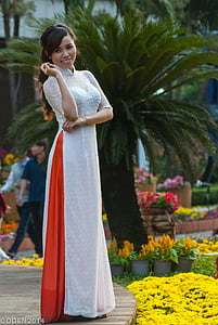 woman standing near sago palm plant thumbnail