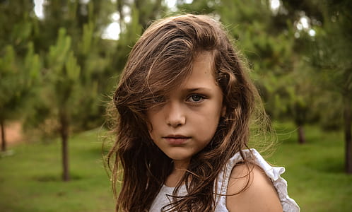 focus photography of girl wearing white sleeveless top thumbnail