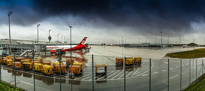 airport runway under dark cloudy sky thumbnail
