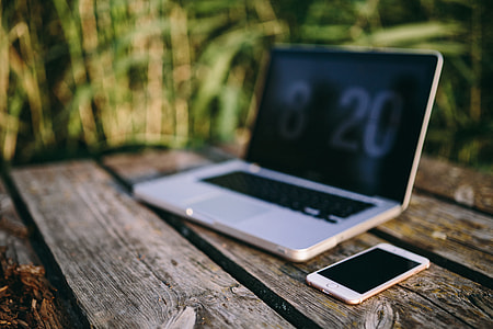 Man working on Macbook at lake thumbnail