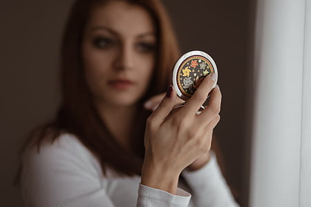 Young beautiful woman doing her make up thumbnail