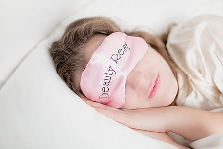 Woman In Beauty Rest Mask In Pillow Photo thumbnail