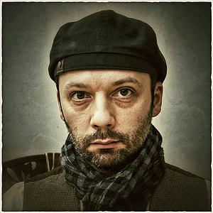 man wearing black and gray checkered scarf thumbnail