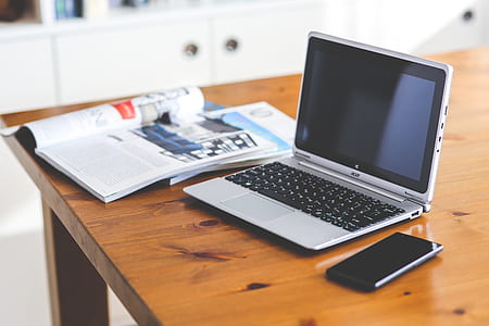 Laptop & cell phone on a wooden desk thumbnail