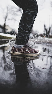 person splashing the water under white cloudy sky photo thumbnail
