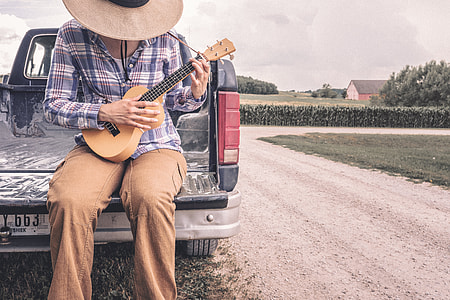 person playing ukulele on truck bed thumbnail