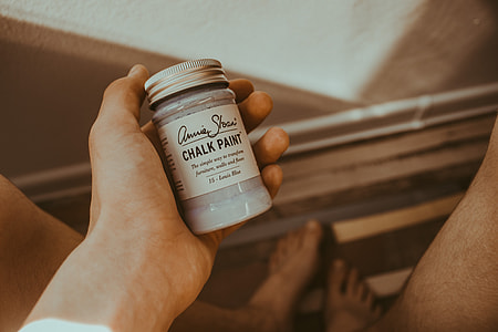 person holding chalk paint bottle thumbnail