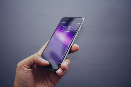 person holding turned-on space gray iPhone 6 thumbnail