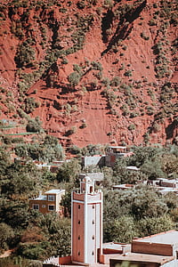 aerial photography of beige buildings near mountain at daytime thumbnail