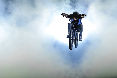 photography of man rides on bicycle with smokes thumbnail
