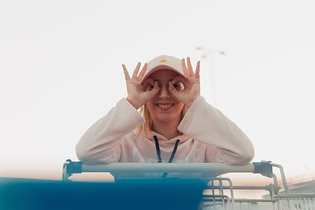 Woman Leaning on Black Shopping Cart thumbnail