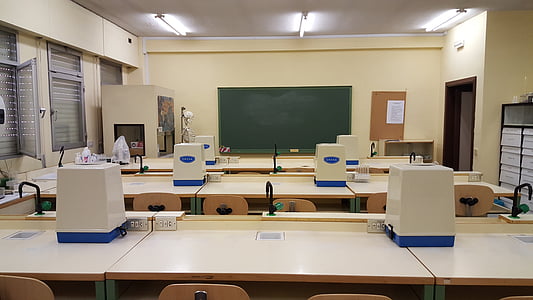 white wooden desks and chairs inside room thumbnail