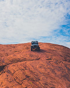 black SUV on brown rock thumbnail