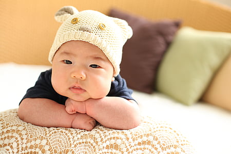 baby wearing white knit cap on focus photo thumbnail
