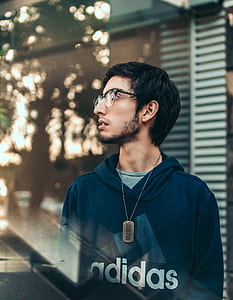 man standing near glass wall thumbnail