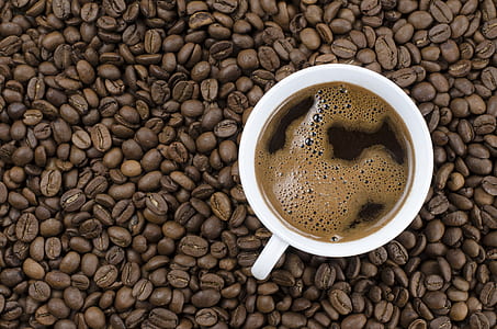 white ceramic teacup filled with coffee thumbnail