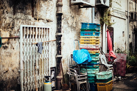 assorted-color plastic crates beside gray building thumbnail