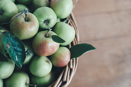 selective focus photography of granny smith apples on brown wicker basket thumbnail
