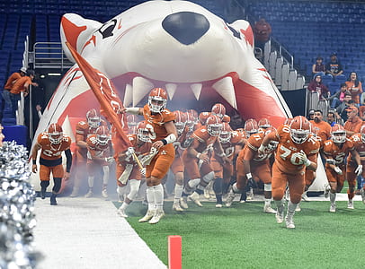 Football Team Running Thru Football Field thumbnail