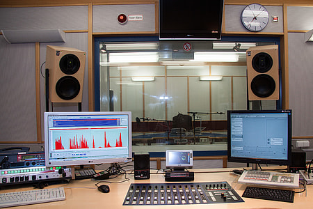 black audio mixer with two computer monitors thumbnail