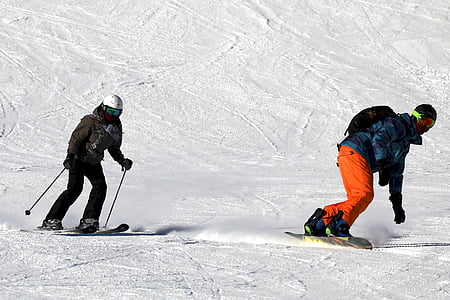 two person snowboarding and skiing on snow at daytime thumbnail