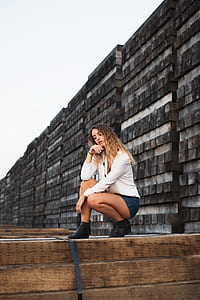woman posing for a photo shoot over brown woodd planks thumbnail