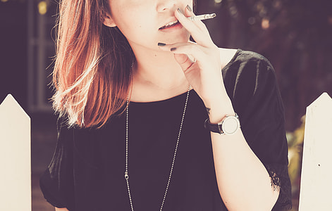 woman with cigarette on her lips thumbnail