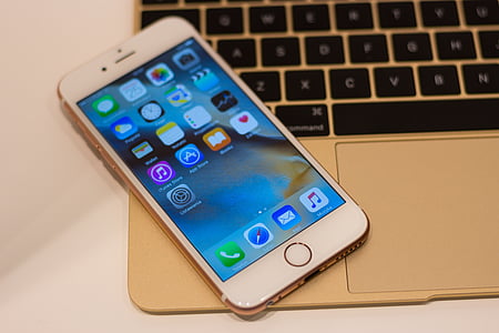 rose gold iPhone 6s on top of 12-inch gold MacBook thumbnail
