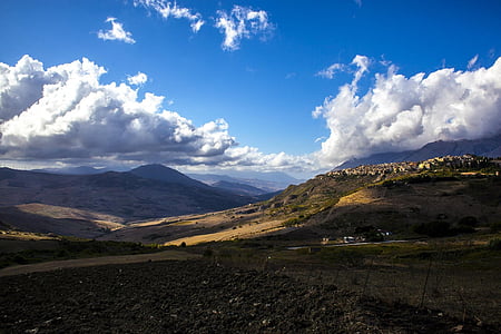 brown mountains and white clouds at daytime thumbnail