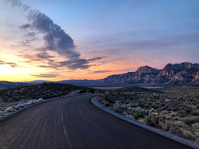 grey asphalt road near mountain thumbnail