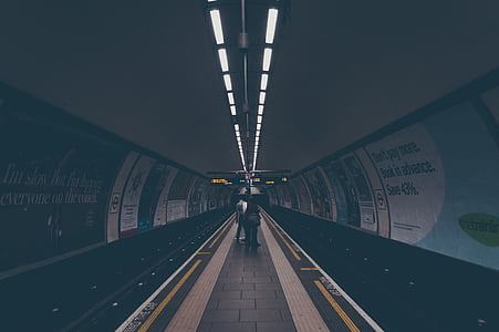people walking on subway under ceiling lights thumbnail