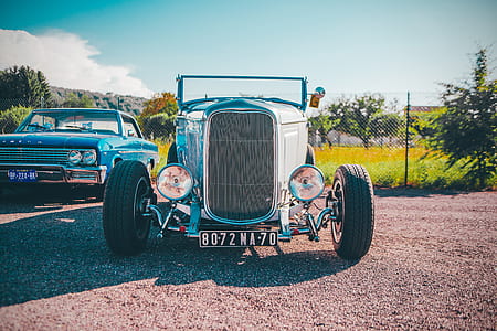 classic convertible coupe parked near metal fence thumbnail