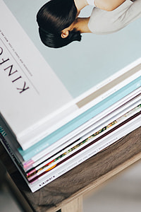 Stack of magazines on the wooden stool thumbnail