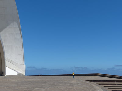 person standing near white concrete building thumbnail