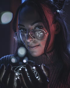 woman holding white lights thumbnail