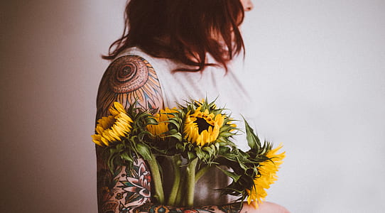 woman holding yellow sunflowers thumbnail