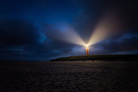 turned on lighthouse during night time thumbnail