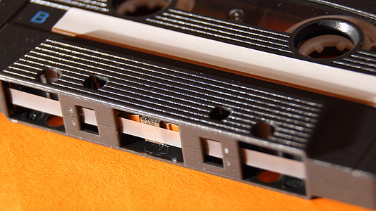 black cassette on yellow surface thumbnail