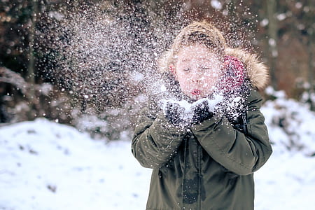 boy blowing snow on his hand thumbnail