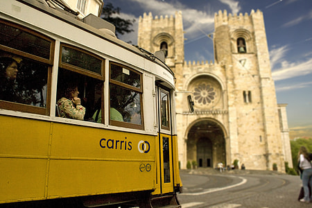 people inside bus beside cathedral thumbnail