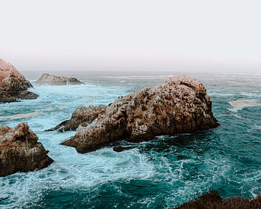 rocky coast under foggy sky thumbnail