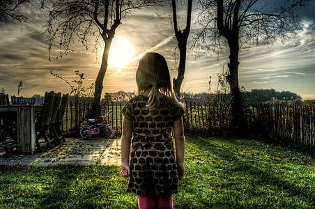 girl standing in front of trees during daytime thumbnail