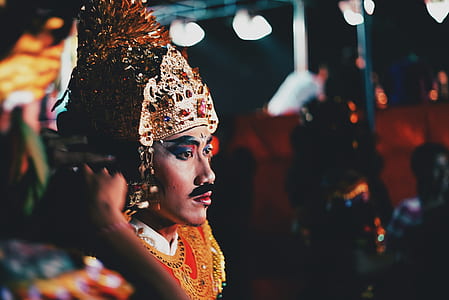 selective focus photography of man wearing gold headdress thumbnail