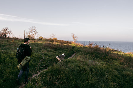 man walking on green grass field thumbnail