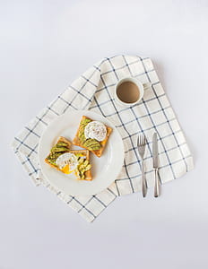 cooked food on round white ceramic plate beside fork and butter knife thumbnail